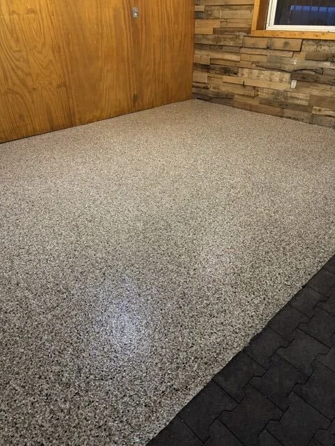 Tan flake epoxy floor installed in a finished basement