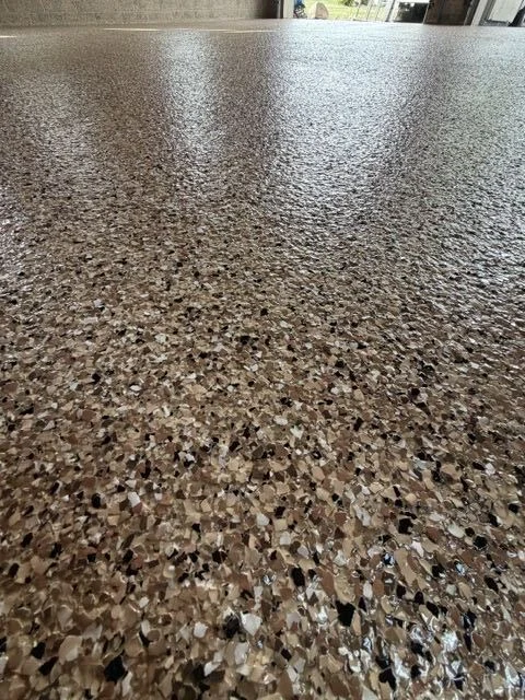 Closeup of a full-broadcast flake epoxy floor system