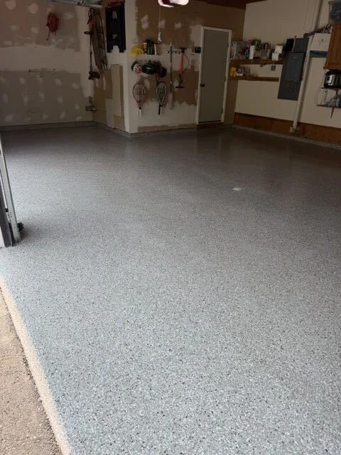 Gray flake epoxy floor installed in a two-car garage by SF Huling