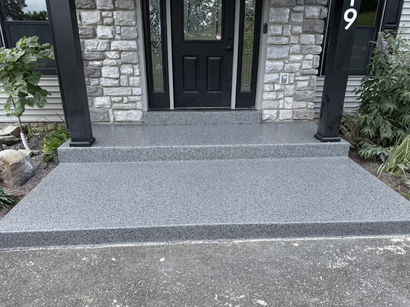 Concrete front entry steps and landing finished with gray flake coating