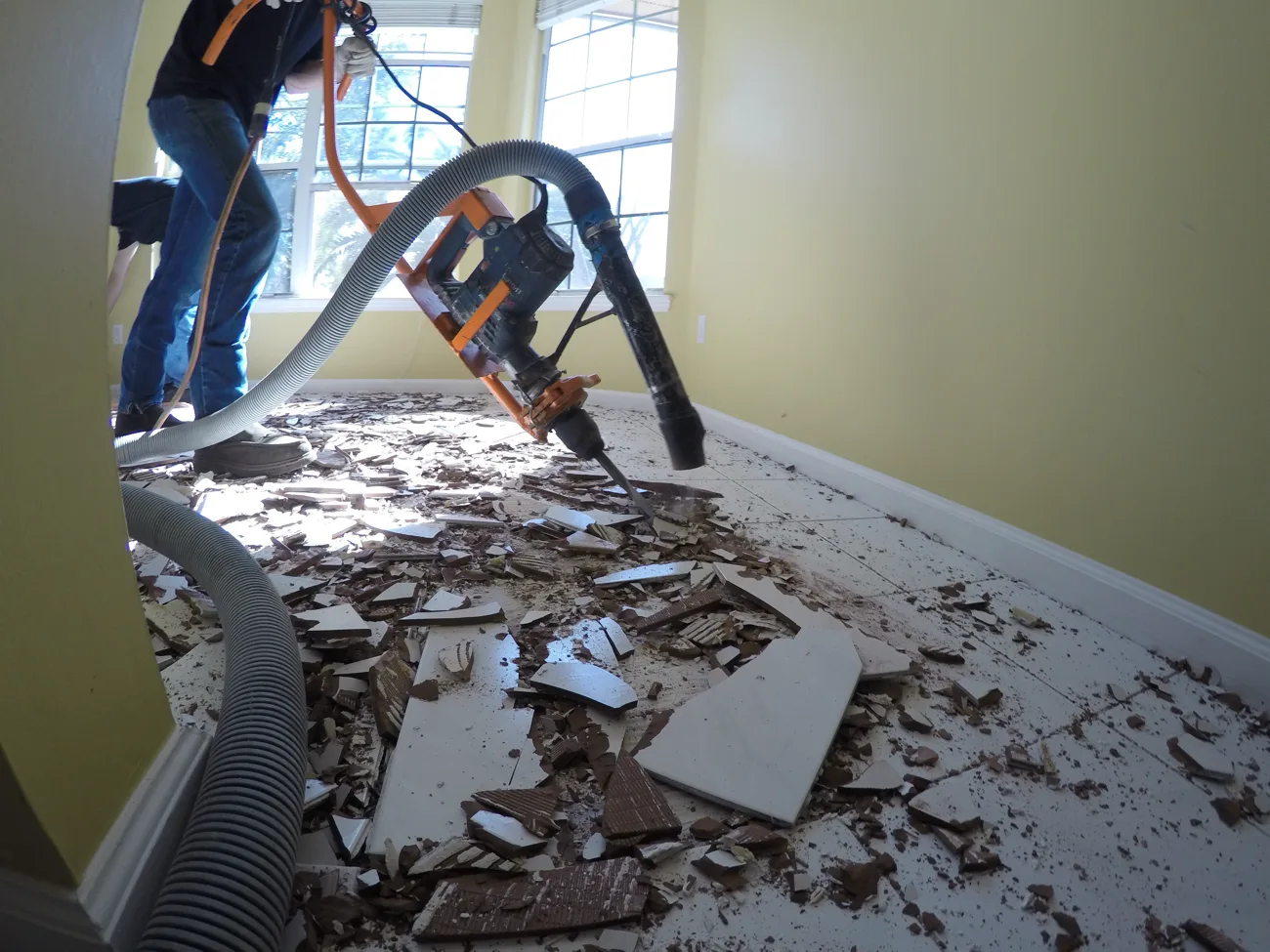 Old tile flooring broken up during floor demolition