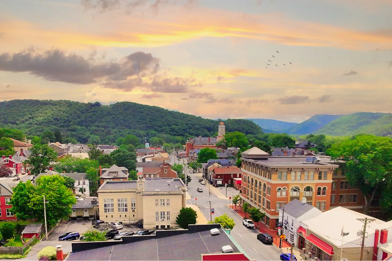 Aerial view of downtown Huntingdon, PA, with wooded ridges beyond the town
