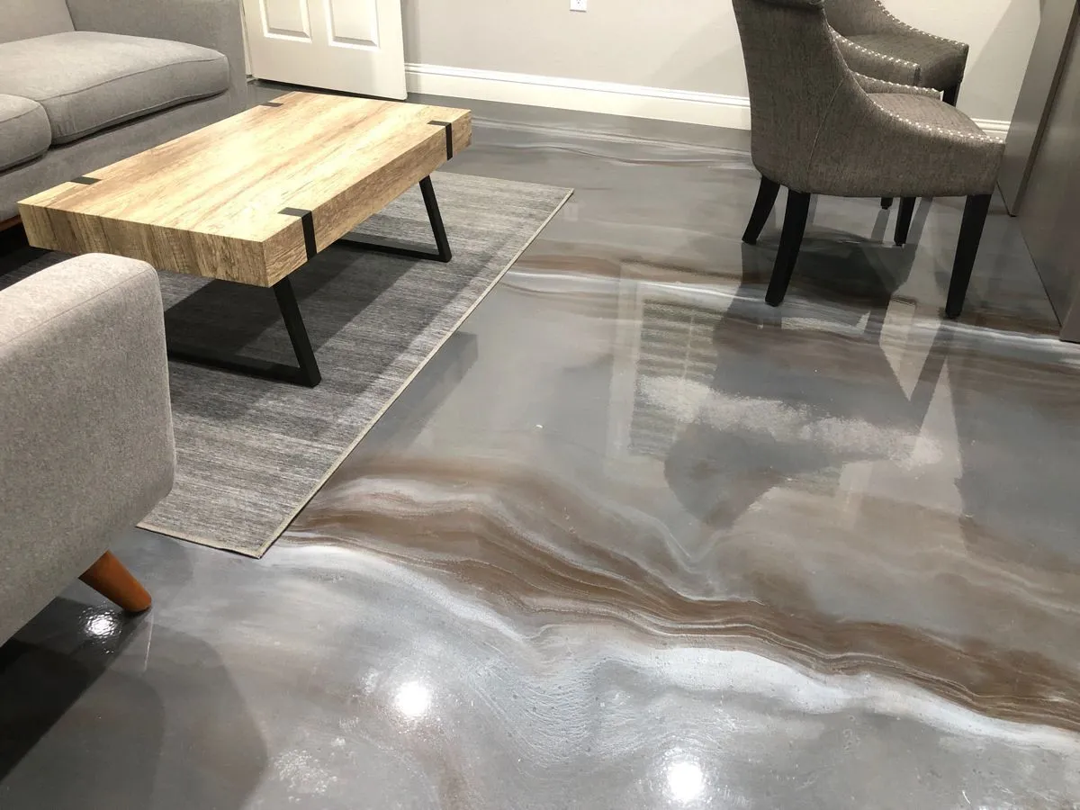 Gray metallic epoxy floor with bronze veining in a finished basement sitting area