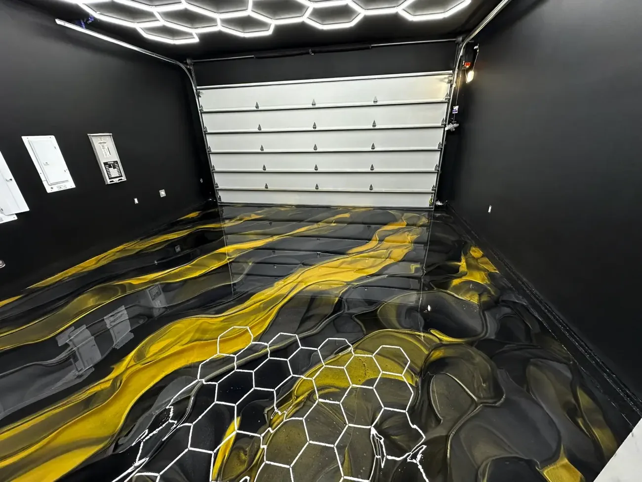 Black and gold metallic epoxy floor in a garage